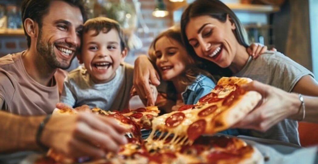 Happy family enjoying pizza together at a family friendly pizza restaurant.