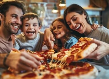 Happy family enjoying pizza together at a family friendly pizza restaurant.